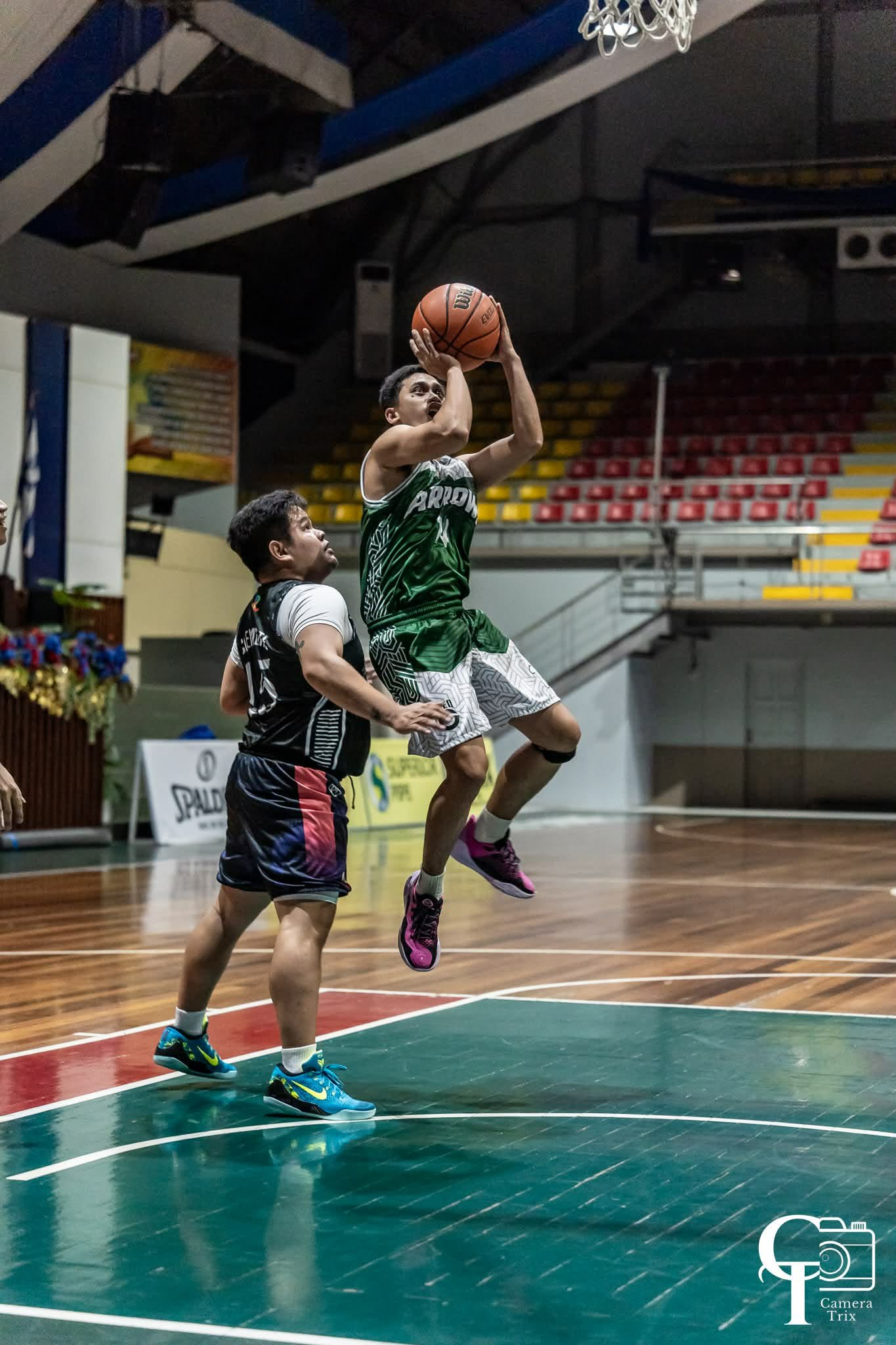 Player rising for a jump shot over a defender